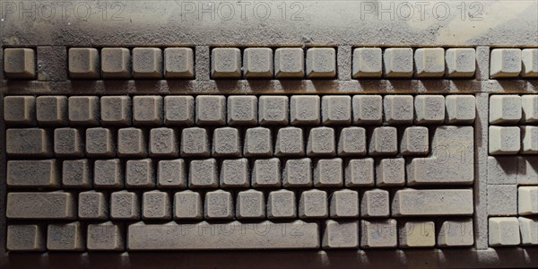 Old vintage computer mechanical keyboard in dust, computer keyboard from the 1980s