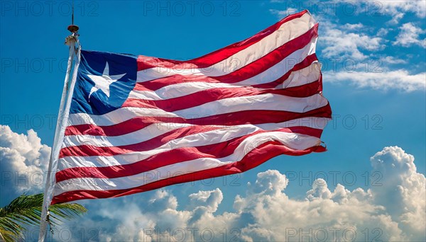 The flag of Liberia, fluttering in the wind, isolated, against the blue sky