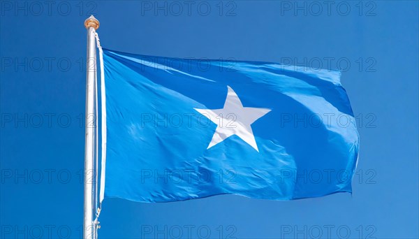 The flag of Somalia, fluttering in the wind, isolated, against the blue sky