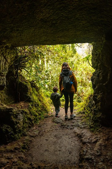 A child and his mother in a cave in the Laurisilva forest of Los tilos de Moya, Gran Canaria