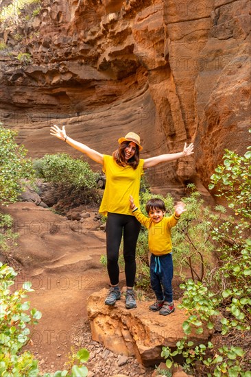 A happy family in the limestone canyon Barranco de las Vacas in Gran Canaria, Canary Islands