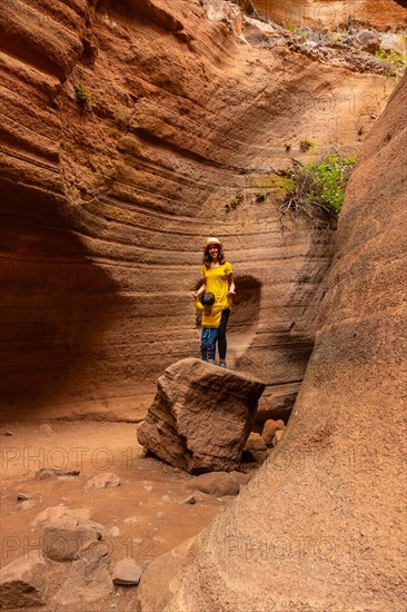 Mother and son enjoying in the limestone canyon Barranco de las Vacas in Gran Canaria, Canary Islands