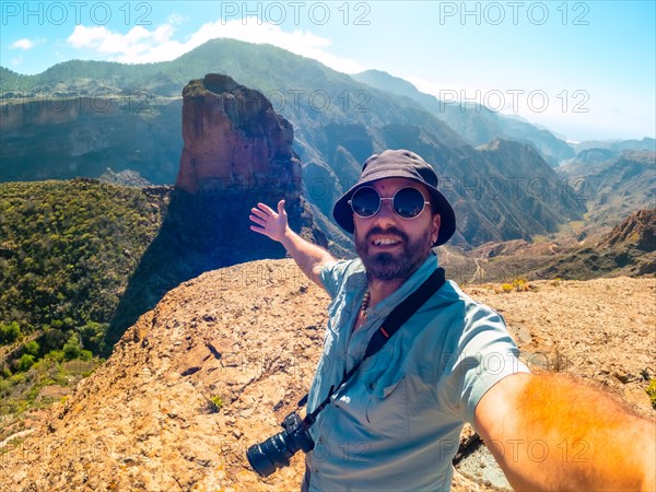 Selfie of a man at the Roque Palmes viewpoint near Roque Nublo in Gran Canaria, Canary Islands