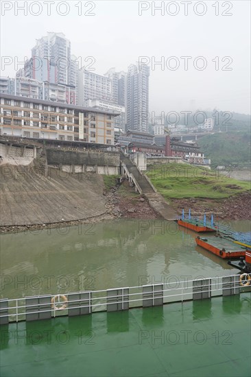 Yichang, Hubei Province, China, Asia, A cloudy day with a view of a river, multi-storey buildings under a grey sky, Asia