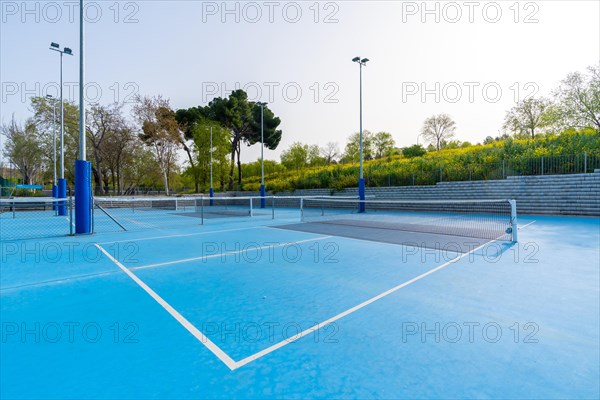 Sunny day in pickleball outdoors blue court with no people around