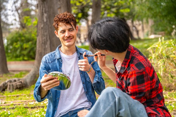 Gay man gesturing agreement making up in a park with his couple