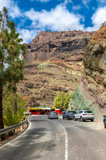 Beautiful road under the natural monument at the Azulejos de Veneguera or Rainbow Rocks in Mogan, Gran Canaria