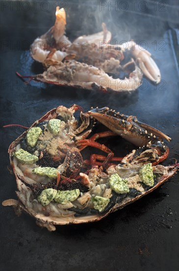 Cooked lobster (homarus) with caviar, vegetables and garlic butter on a plancha, Atlantic coast, Vandee, France, Europe