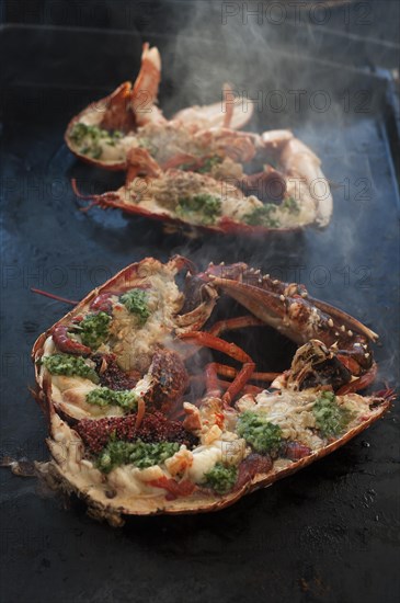 Cooked lobster (homarus) with caviar, vegetables and garlic butter on a plancha, Atlantic coast, Vandee, France, Europe