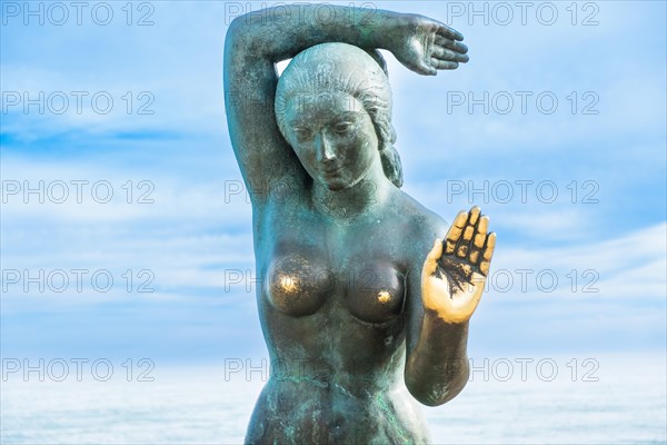 Bust of a siren or mermaid with worn hands and breasts in Sitges, Spain, Europe