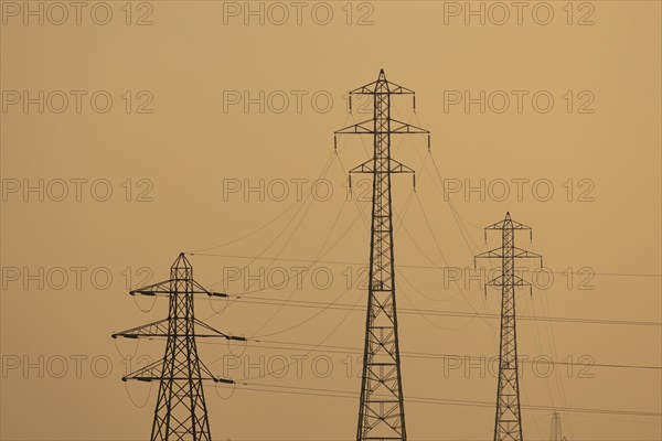 Electricity pylons at sunset, England, United Kingdom, Europe