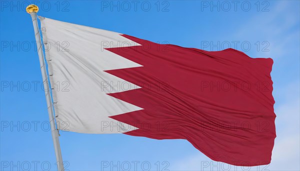 The flag of Bahrain flutters in the wind, isolated against a blue sky