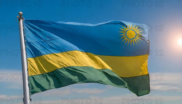 The flag of Rwanda, fluttering in the wind, isolated, against the blue sky