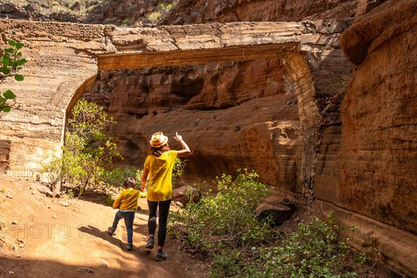 A woman with her child in the limestone canyon Barranco de las Vacas on Gran Canaria, Canary Islands