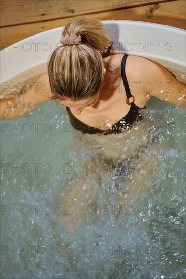 Top view of a woman relaxing in hot tub