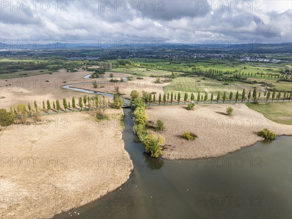 Aerial view of the Radolfzeller Aach, which flows into western Lake Constance surrounded by a belt of reeds, behind it the Raolfzeller Aachried, on the horizon the Hegauberge, district of Constance, Baden-Wuerttemberg, Germany, Europe