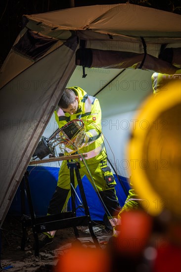 Engineer focused on a project on a construction site at night with artificial lighting, Galsfaserbau, Calw, Black Forest, Germany, Europe