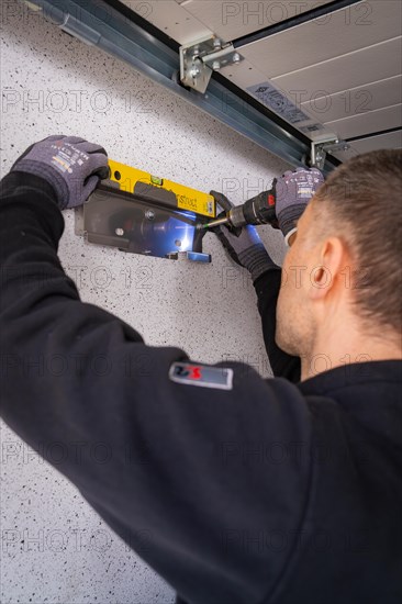 A craftsman uses a spirit level for precise alignment work, solar systems construction, crafts, Muehlacker, Enzkreis, Germany, Europe