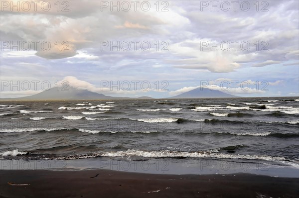 Underway near Rivas, Lake Nicaragua, Ometepe Island in the background, Nicaragua, Wave breaking on the shore of a lake with volcanoes on the horizon, Central America, Central America