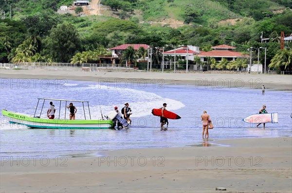 San Juan del Sur, Nicaragua, People with surfboards prepare for surfing on the beach, Central America, Central America