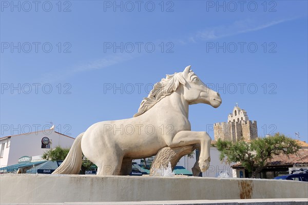 Statue of a Camargue horse in a fountain, Les Saintes-Maries-de-la-Mer, Camargue, Bouches-du-Rhone, Provence-Alpes-Cote d'Azur, South of France, France, Europe