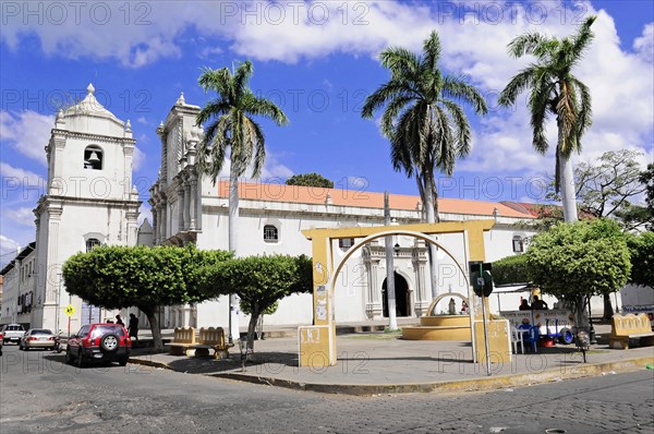 Leon, Nicaragua, A large church with two towers, surrounded by palm trees under a blue sky, Central America, Central America