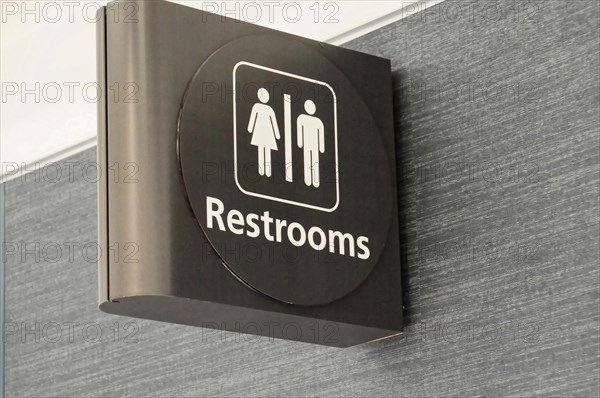 AUGUSTO C. SANDINO Airport, Managua, Nicaragua, sign for a unisex toilet on a wall in the airport, Central America, Central America