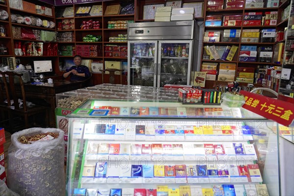 Shanghai, China, Asia, A view into a small shop with a large selection of cigarettes and a smiling dealer, People's Republic of China, Asia