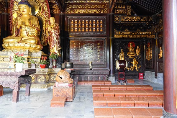 Chongqing, Chongqing Province, China, Asia, Golden Buddha statue in a Chinese temple with altar and incense sticks, Asia