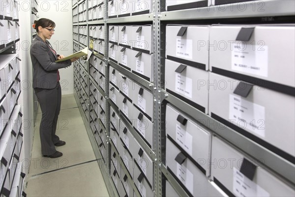 An employee of the Federal Commissioner for the Records of the State Security Service of the former German Democratic Republic, BStU, looks at Stasi files. Files and documents of the Ministry for State Security of the GDR are stored in the Stasi Records Authority, 17.01.2015., Berlin, Berlin, Germany, Europe
