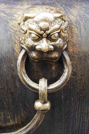 China, Beijing, Forbidden City, UNESCO World Heritage Site, Close-up of a detailed lion's head handle on a bronze cauldron, Forbidden City (Palace Museum) in Beijing, China, Asia