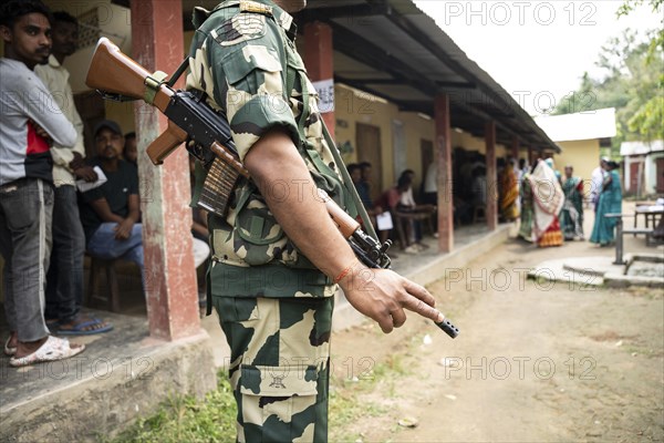 BOKAKHAT, INDIA, APRIL 19: A security personnel stands guard at a polling station during the first phase of the India's general elections on April 19, 2024 in Bokakhat, Assam, India. Nearly a billion Indians vote to elect a new government in six-week-long parliamentary polls starting today