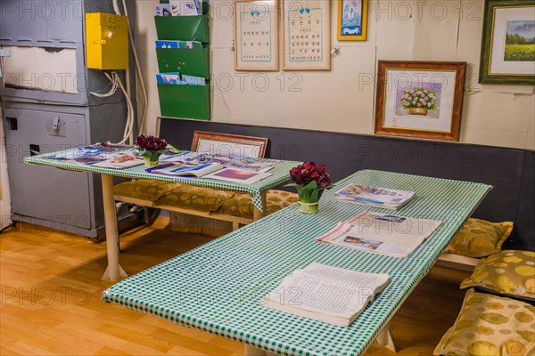 Interior of saloon with magazines om tables inside battleship on display at Unification Park in Gangneung, South Korea, Asia