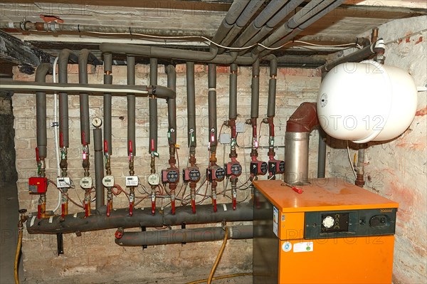 23.01.2023 Apartment building in 19249 Luebtheen, Mecklenburg-Western Pomerania, meter for measuring the heat consumption of heating in the rented flats and gas boiler with expansion tank, Luebtheen, Mecklenburg-Western Pomerania, Germany, Europe