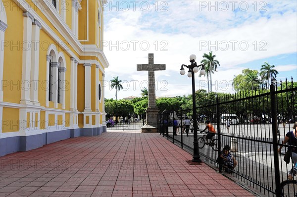 Granada, Nicaragua, forecourt of a yellow church with a large cross, surrounded by a wrought-iron railing and palm trees, Central America, Central America -, Central America