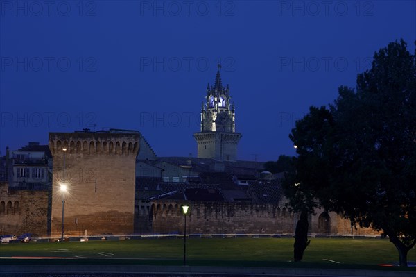 Old city wall and town hall tower at night, Avignon, Vaucluse, Provence-Alpes-Cote d'Azur, South of France, France, Europe