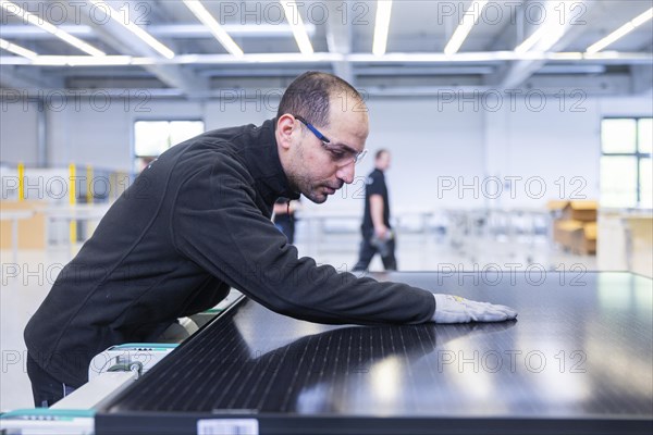 Sunmaxx PVT is a new innovative developer of photovoltaic thermal solar modules. The Fraunhofer ISE has confirmed an overall efficiency of 80% for the PX-1 premium module. The innovation is the combination of photovoltaics and solar thermal energy in one element. Employee Emad Sidhorn at a PVT module, Ottendorf-Okrilla, Saxony, Germany, Europe