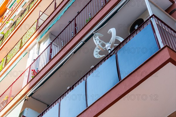 Balcony power plant and mini wind turbine on a balcony of a high-rise building in Barcelona, Spain, Europe