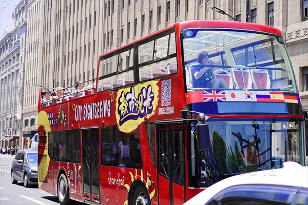 Shanghai, Sightseeing double-decker bus with colourful design drives through the city, Shanghai, China, Asia