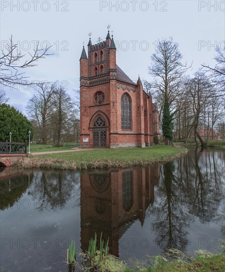 The Catholic Church of St Helena in Ludwigslust Castle Park is reflected in the water of a pond, the church was built in 1806 - 1809 as the first neo-Gothic brick building in Mecklenburg, Ludwigslust, Mecklenburg-Vorpommern, Germany, Europe