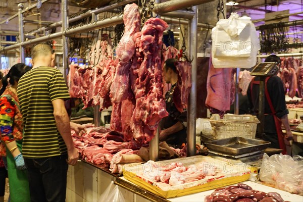 Chongqing, Chongqing Province, China, View of a busy meat market with customers and hanging pieces of meat, Chongqing, Chongqing Province, China, Asia