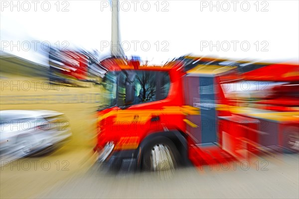 Fire engine in motion with strong blur, suggesting dynamics