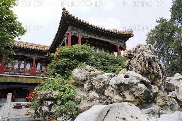 China, Beijing, Forbidden City, UNESCO World Heritage Site, An ornate Chinese pavilion peeking out from behind an arrangement of rocks, Forbidden City (Palace Museum) in Beijing, China, Asia