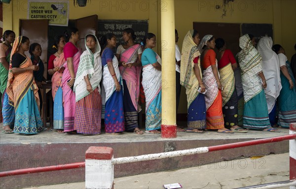 BOKAKHAT, INDIA, APRIL 19: Voters wait in line at a polling station to cast their votes during the first phase of the India's general elections on April 19, 2024 in Bokakhat, Assam, India. Nearly a billion Indians vote to elect a new government in six-week-long parliamentary polls starting today