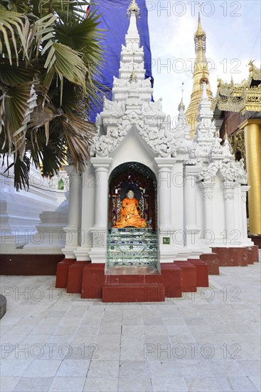 Shwedagon Pagoda, Yangon, Myanmar, Asia, Buddha statue in a niche with white and gold decoration, Asia
