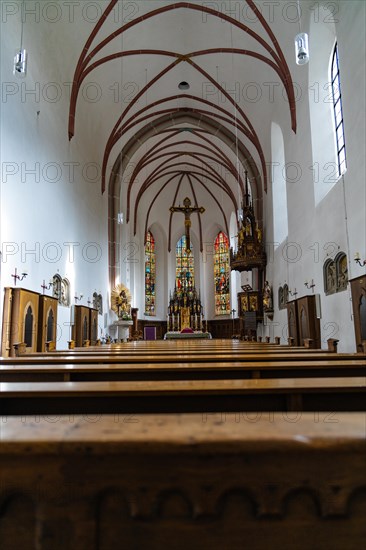 Interior view of a church with wooden pews and coloured stained glass windows, Bad Reichenhall, Bavaria, Germany, Europe