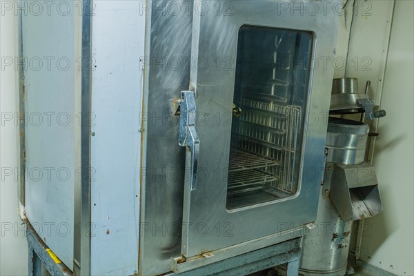Large metal proofing cabinet with glass door in kitchen of battleship on display at Unification Park in Gangneung, South Korea, Asia