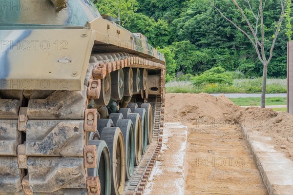 Side view of left tracks on tank used in Korean war on display in public park in Nonsan, South Korea, Asia
