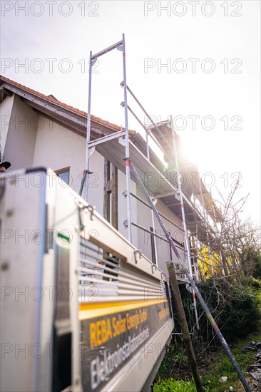 A scaffold with ladder stands on a house in the sunlight, solar systems construction, craft, Muehlacker, Enzkreis, Germany, Europe