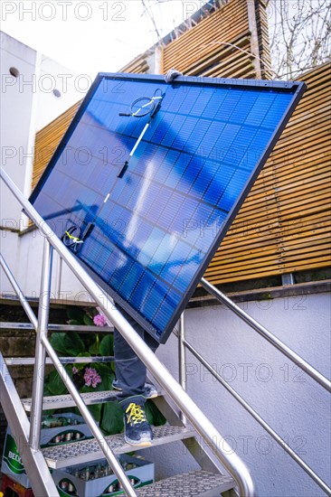 A technician installs a solar panel on a staircase, Solar Anlagen Bau, Handwerk, Muehlacker, Enzkreis, Germany, Europe